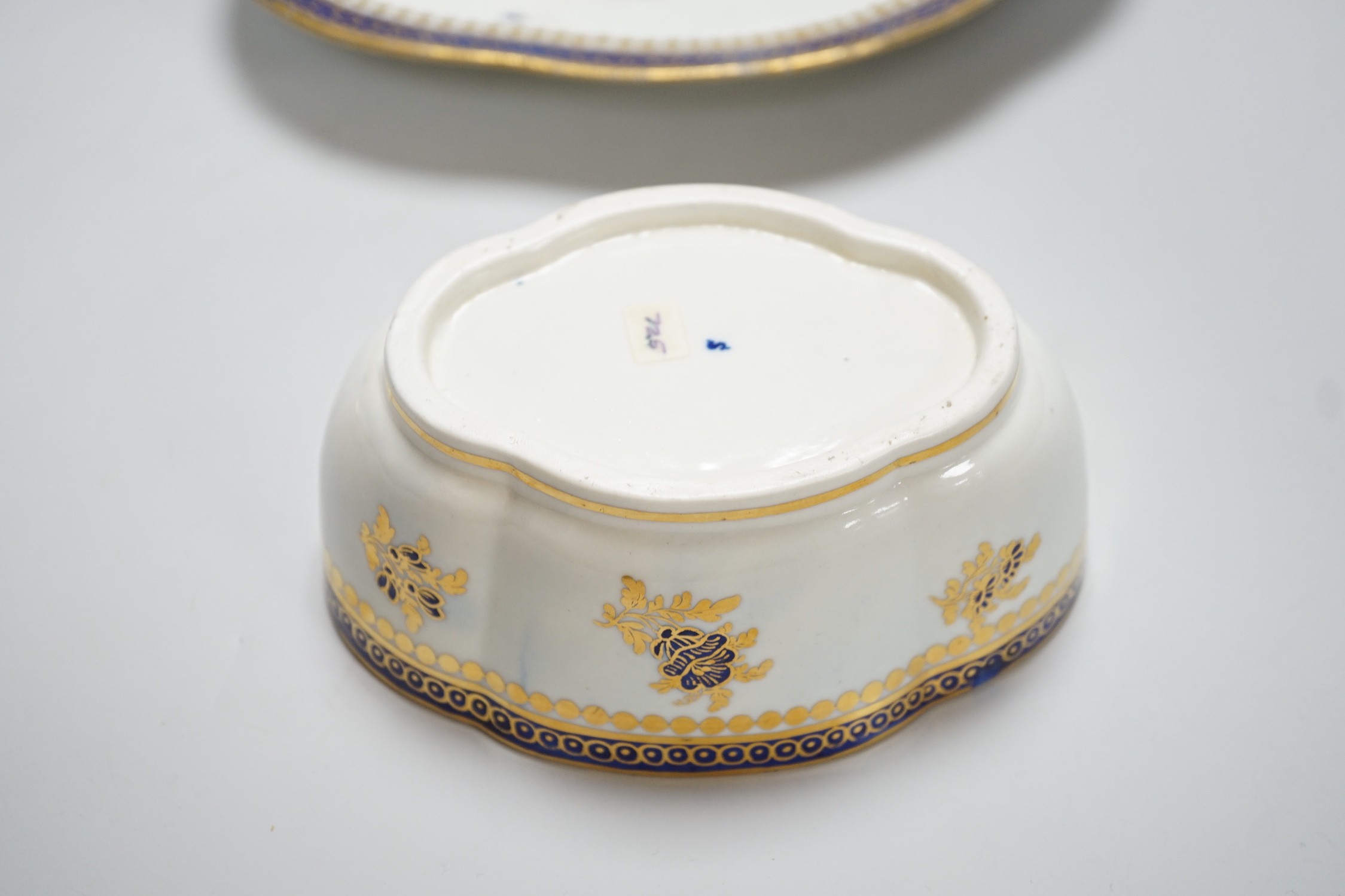 An 18th century Caughley tureen cover and stand with blue and gilt decoration, stand mis-fired to border, S mark to stand and base, stand 23cms wide